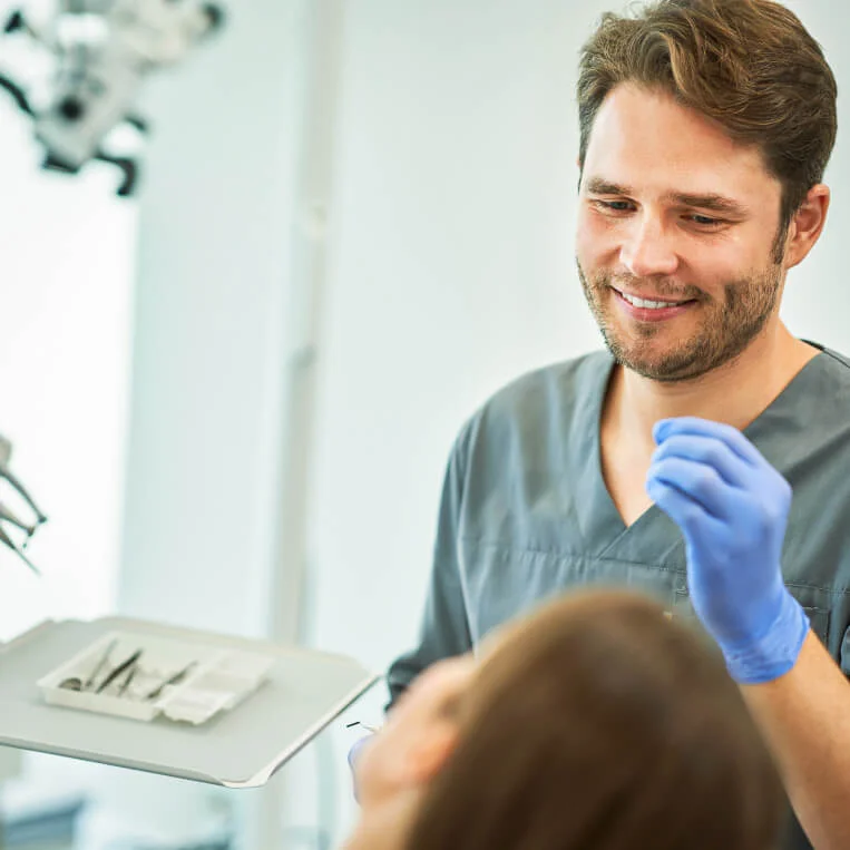 Zahnarzt erklärt der Patientin Online-Terminvergabe von Dr. Flex in der Zahnarztpraxis